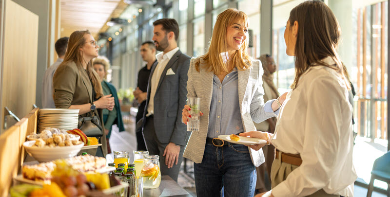 Mehrere Personen unterhalten sich am Frühstücksbuffet - Link auf Seite: World-Café Düsseldorf