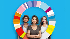 Eine junge Frau steht vor dem Gründungswoche-Farbkreis, eine Frau und ein Mann dahinter; Link zum Rückblick 2016